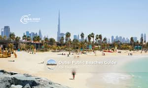 Tourists relaxing on a clean public beach in Dubai with clear water, soft sand, and the city skyline in the background.