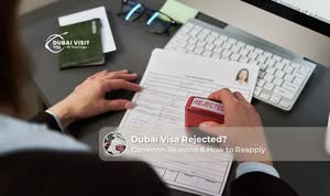 Dubai visa rejection notice with passport and travel documents on a desk.